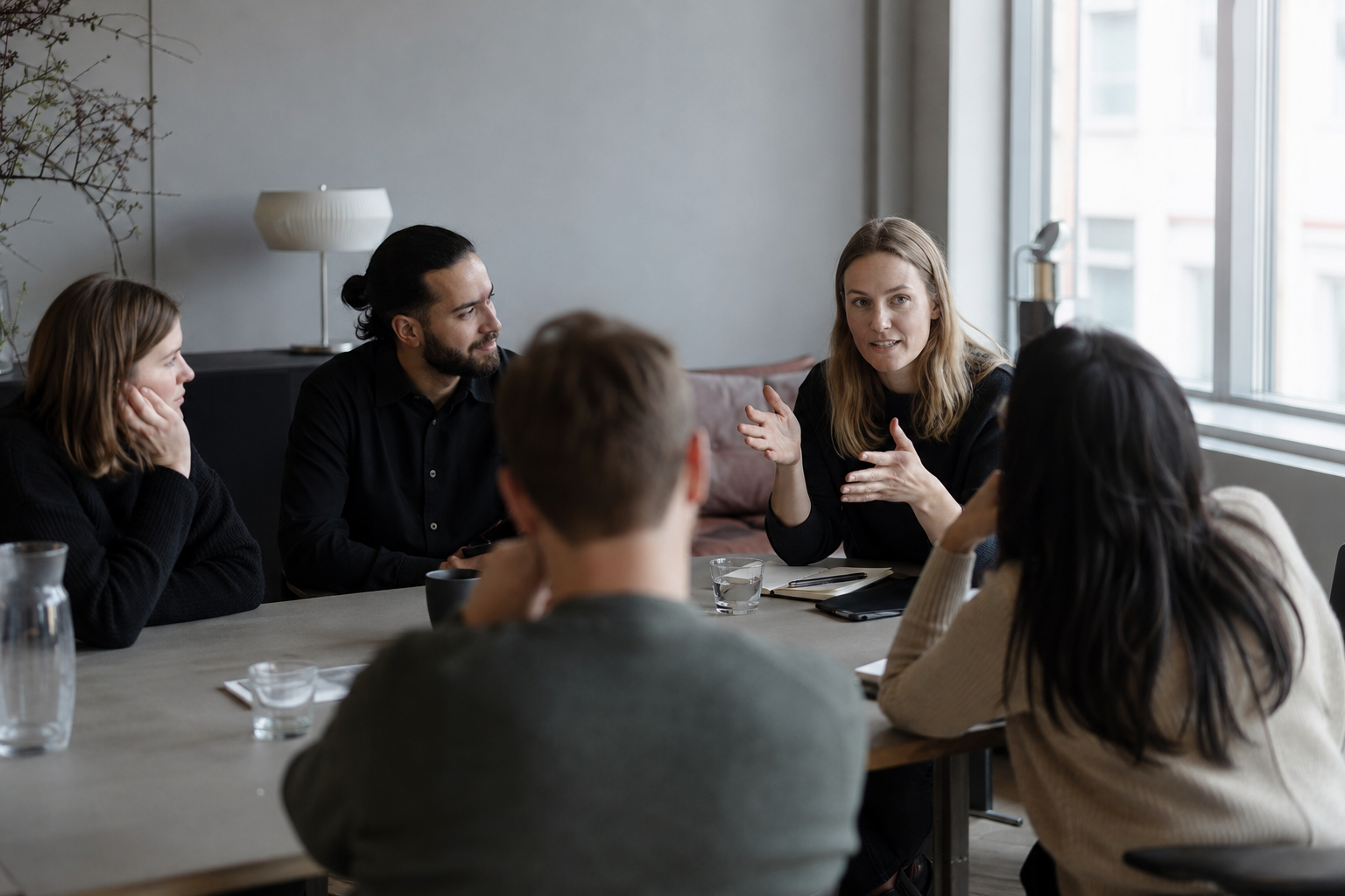 A team in an open discussion where someone speaks their mind.